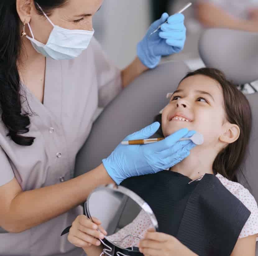 A child undergoing a tooth sealant procedure.